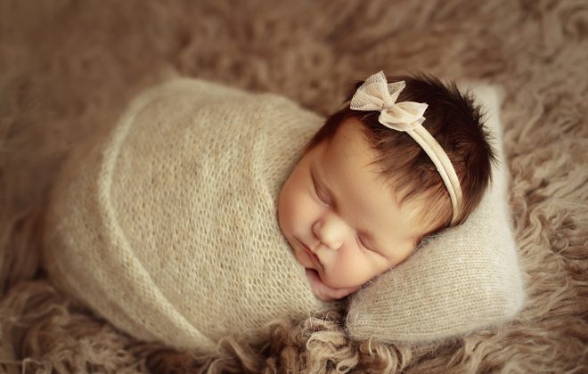 newborn baby with tan angora wrap and tan headband