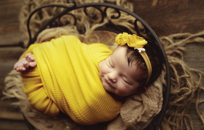 smiling newbonr girl with rich yellow accent