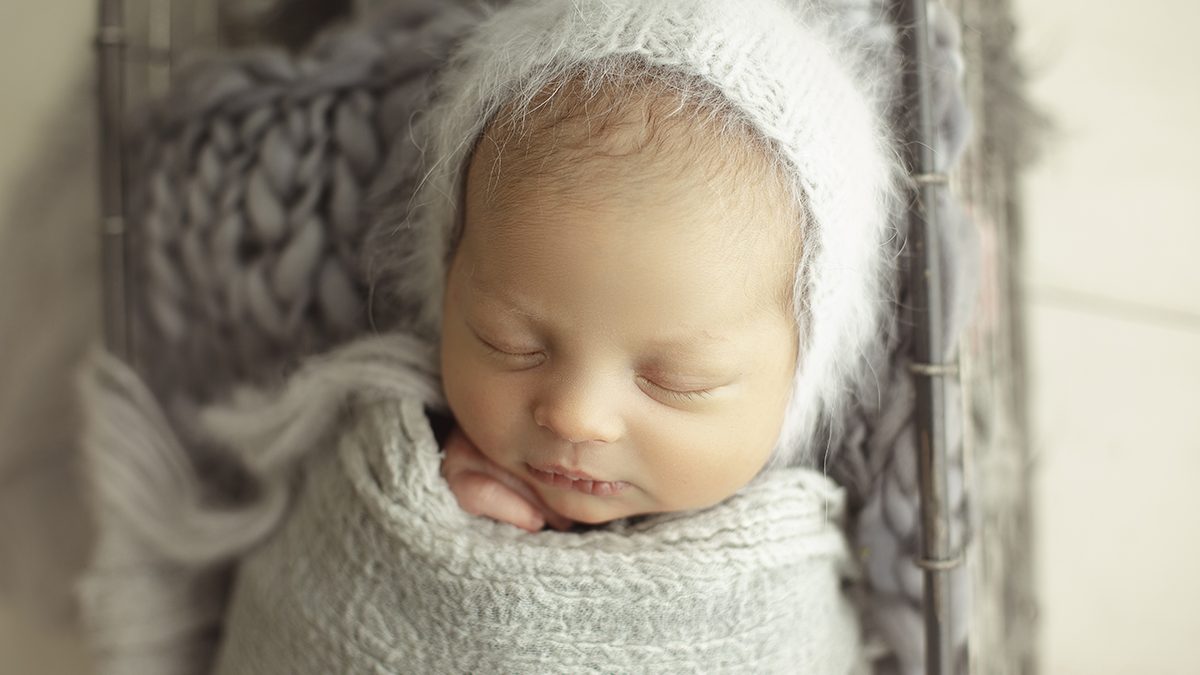 newborn wrapped with gray textured wrap