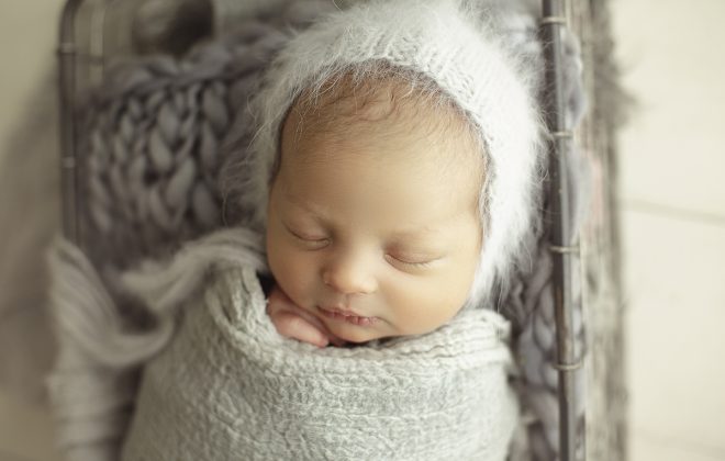 newborn wrapped with gray textured wrap