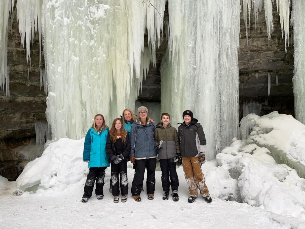 group photo of 2 adults and 4 kids at the eben ice caves in Michigan's upper peninsula