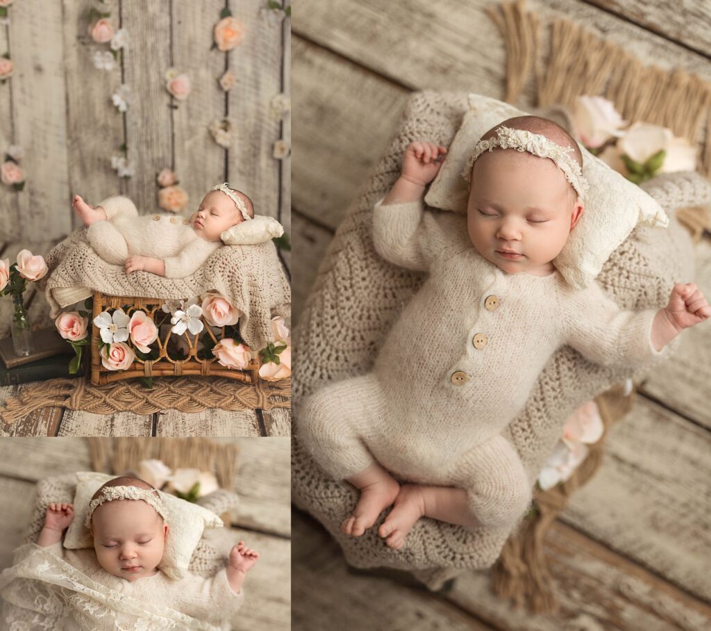 newborn baby in a cream knit jumper, posed with flowers in pinks and whites.